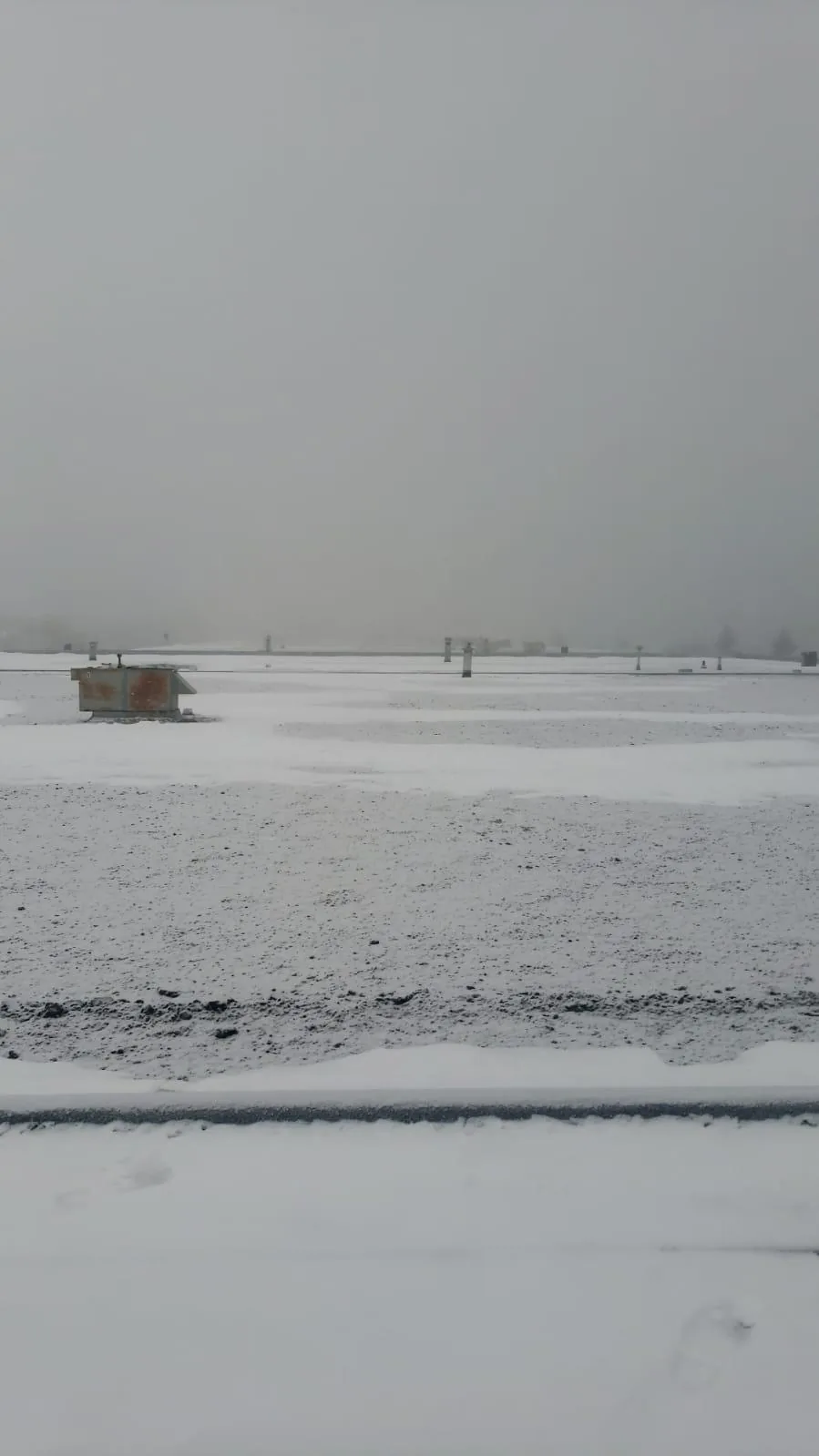 Snow-covered flat roof in extreme cold weather, North America