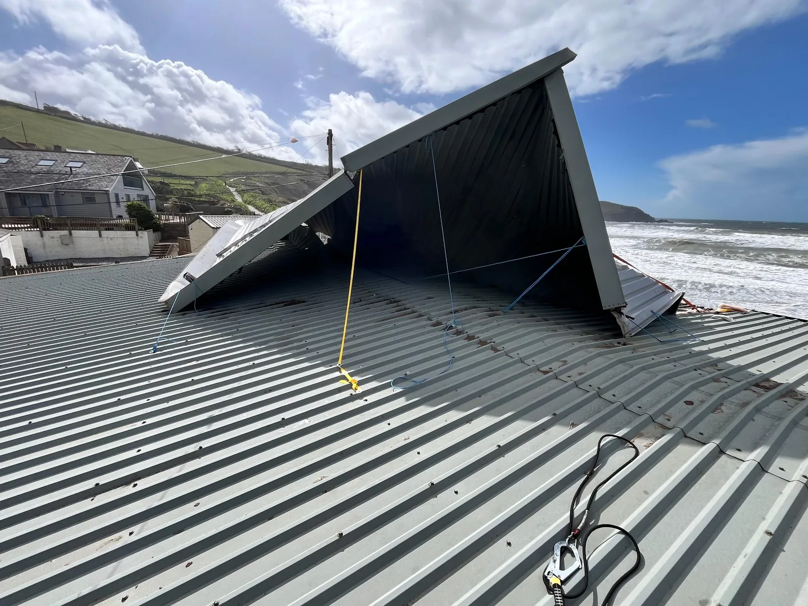 Storm-damaged coastal roof being assessed for repair